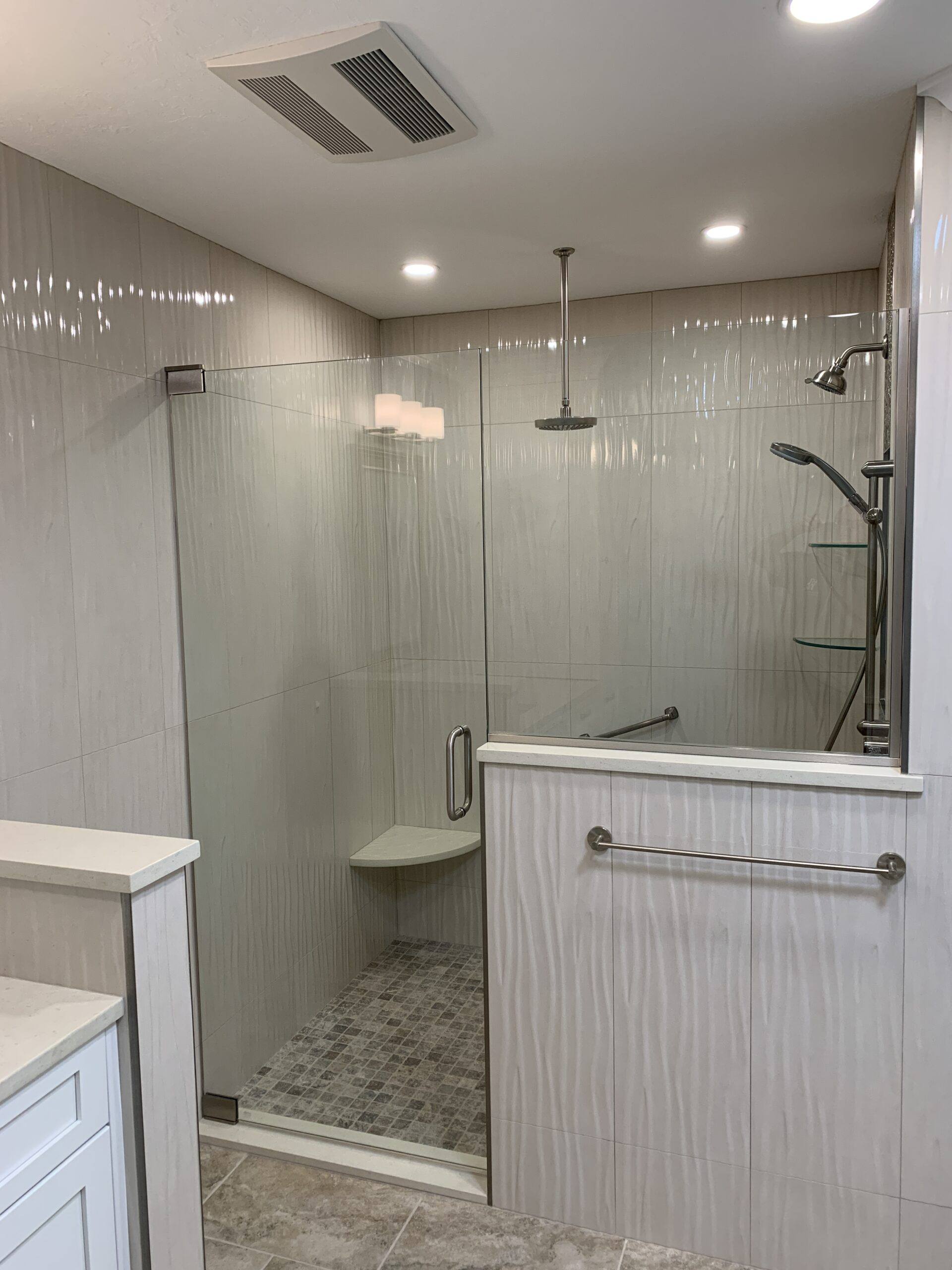 Venice FL bathroom remodel with curbless shower, frameless glass, and freestanding soaking tub
